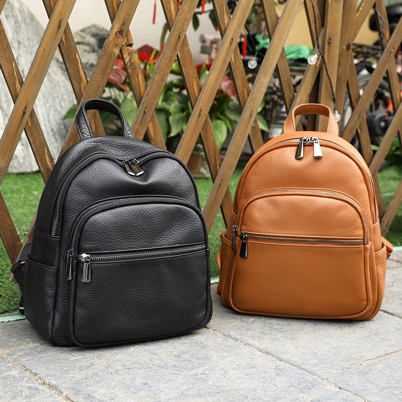 Brown Leather Medium Backpack for Women and Black Leather Medium Backpack for Women on floor