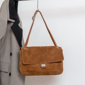 Slouchy Suede Medium Flap shoulder bag Leather Trim Brown hanging on a rack