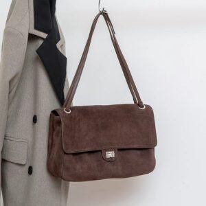 Slouchy Suede Medium Flap shoulder bag Leather Trim Dark Brown hanging on a rack