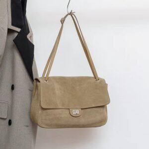 Slouchy Suede Medium Flap shoulder bag Leather Trim Sand hanging on a rack